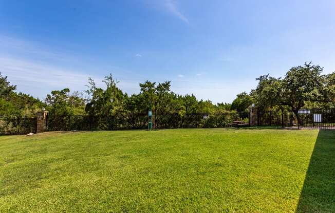 a large grassy area with trees in the background at The Verandah, Austin