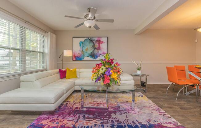 a living room filled with furniture and a large window