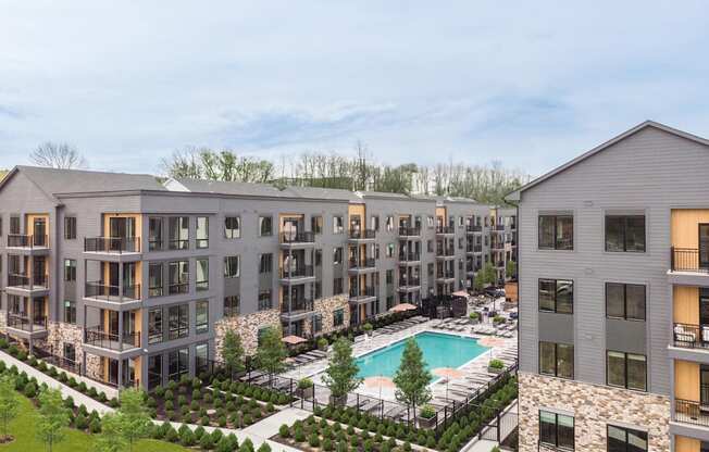 an aerial view of an apartment building with a swimming pool