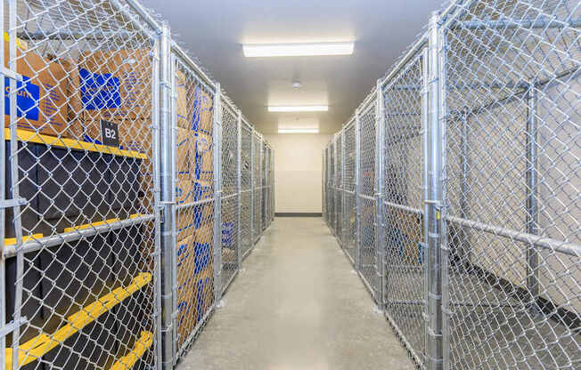 A long hallway with boxes on the shelves and a yellow line on the floor.