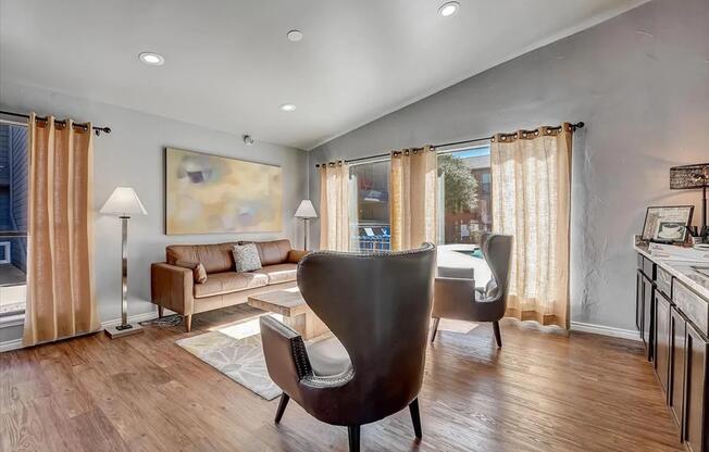 a living room filled with furniture on top of a hard wood floor