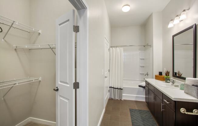 a bathroom with a shower and a sink and a mirror