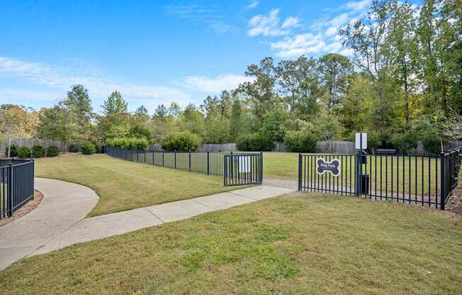 A black metal fence with a dog bone sign on it.