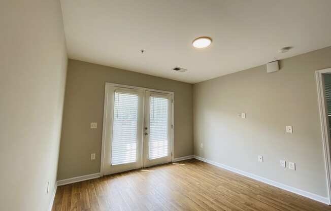 Living room with practical hardwood flooring at Oasis at Cedar Branch in Wilmington, NC