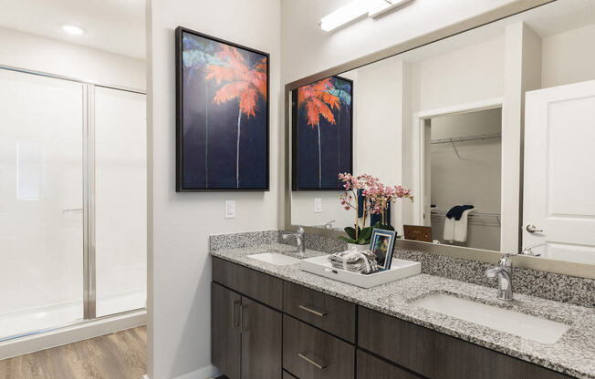 Designer bathroom with granite countertops and double sinks at Residences at The Green in Lakewood Ranch, FL