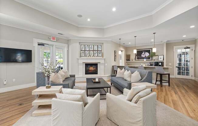 A living room with a grey couch and a fireplace.