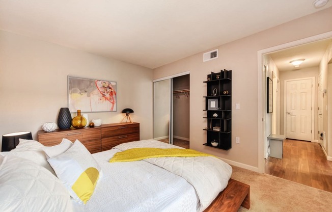 Red Wall Bedroom with Full Sized Mattress and Wooden Frame, White Comforter and Yellow Blanket, Wood Dresser, 