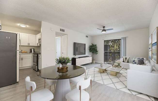 a living room with a table and chairs and a kitchen