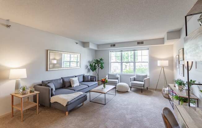 the living room of a two bedroom apartment at the enclave at woodbridge apartments in sugar land