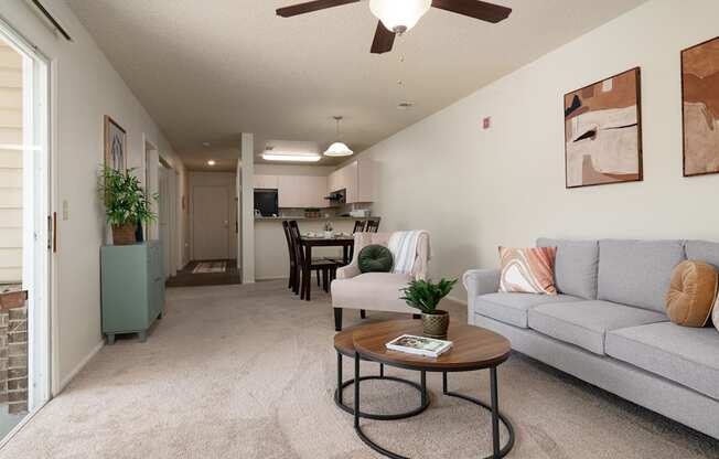 the living room and dining room of an apartment with a couch and a table