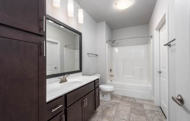 A bathroom with a white tub and a white toilet.