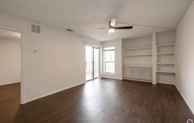 Empty room with wooden floor and white walls.