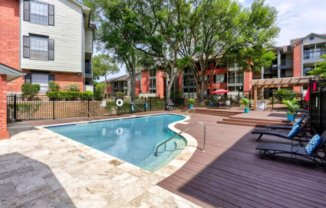 a house with a pool in front of a brick building