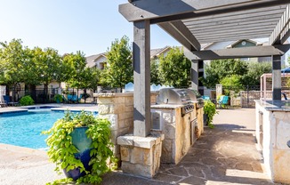Entertain poolside with an outdoor grilling area and dine al fresco
