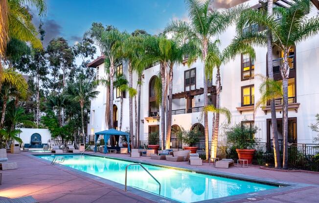 resident pool at sunset with palm tree landscaping at The Promenade Rio Vista, California