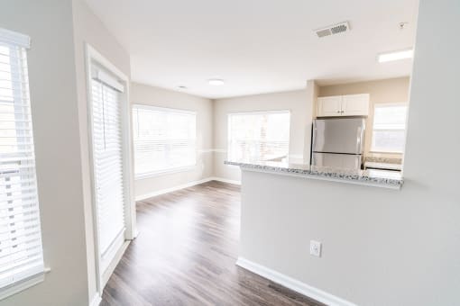 an empty kitchen and living room with a large window at Merion Milford Apartment Homes, Milford, CT