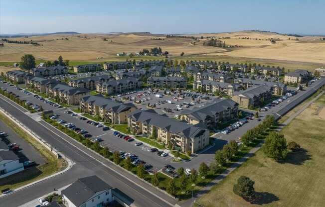 an aerial view of a subdivision with cars parked in a parking lot