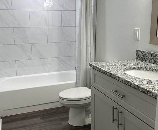 a bathroom with a shower and a toilet in it at Stuart Woods* Apartments, Herndon, Virginia