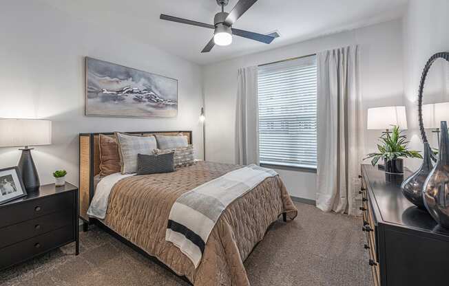 a bedroom with a bed and a ceiling fan