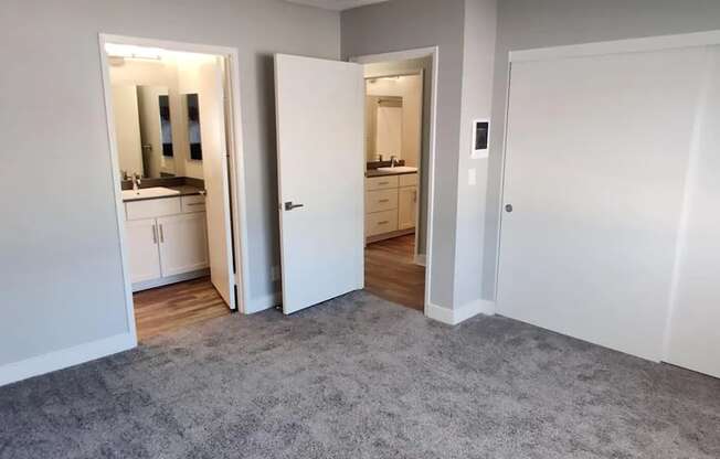 a living room with a carpet and a door to a bathroom