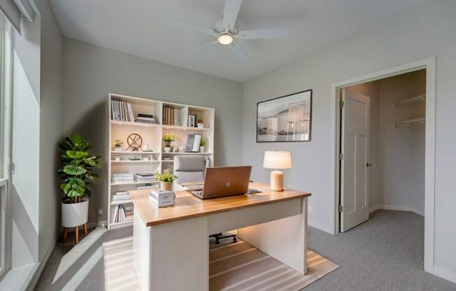 a home office with a desk and a laptop computer