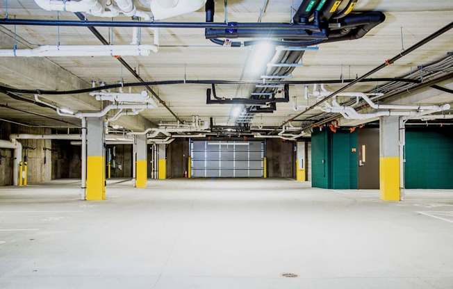 Underground parking lot at the modern apartment complex, featuring state-of-the-art electric vehicle chargers. A well-lit and spacious area with designated charging stations, ensuring convenience for residents with electric cars.