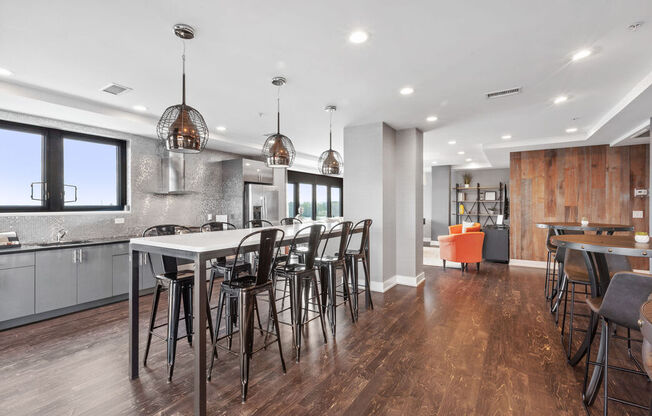 a kitchen with a long island with a bunch of chairs around it