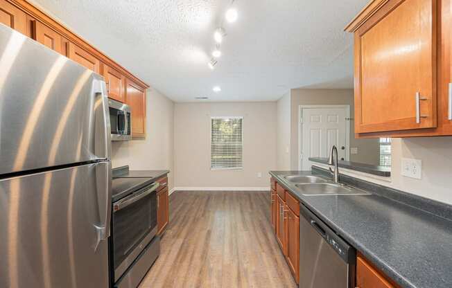 a kitchen with stainless steel appliances and wooden cabinets