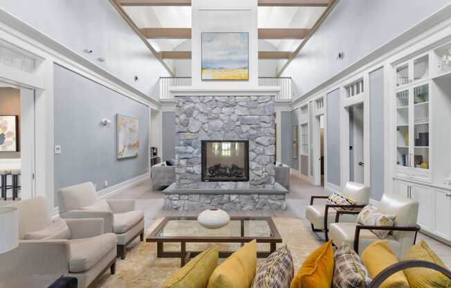 a living room filled with furniture and a large stone fireplace