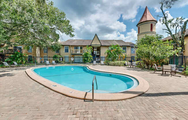 a swimming pool with a building in the background