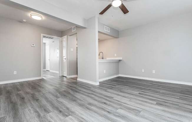 A room with a ceiling fan and light fixture.