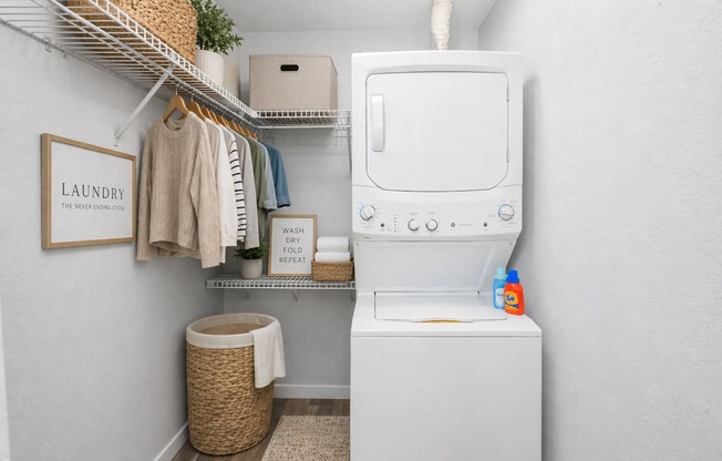 A small laundry room with a washer and dryer.