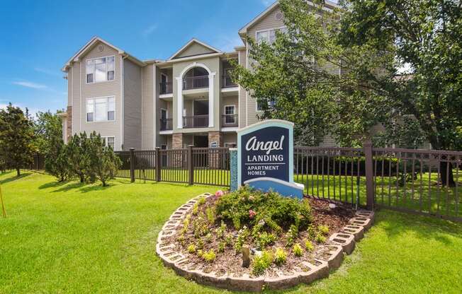 Monument entrance sign welcoming residents and visitors at Angel Landing apartments in Pensacola, FL