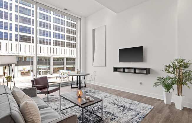 a living room with a large window and a couch