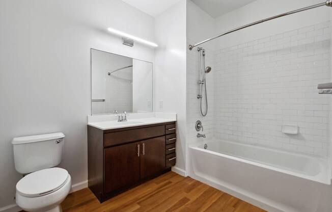 A white bathroom with a toilet, sink, and bathtub.