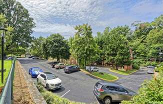 a view of a parking lot with cars and trees