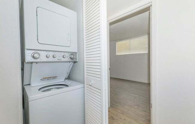 A white oven with a stove top and a microwave is in a kitchen.