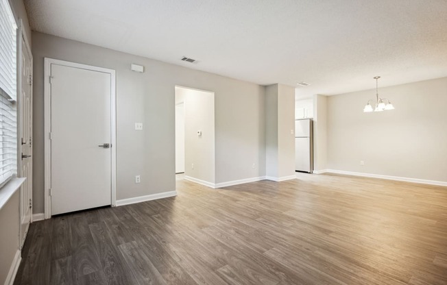 an empty living room with a hardwood floor