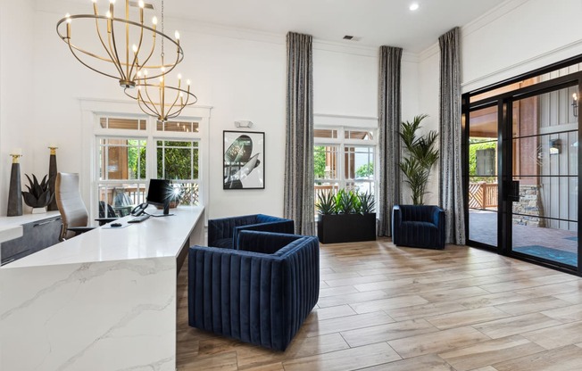 a lobby with blue chairs and a white counter