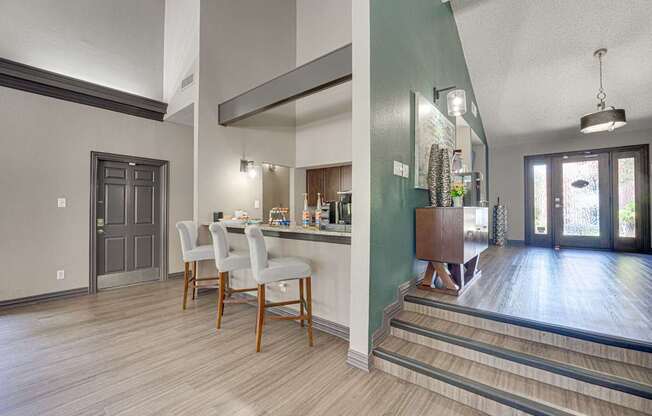 A kitchen with a dining table and chairs.