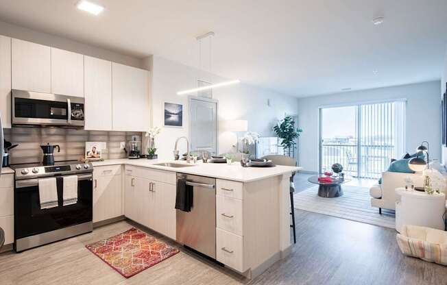 A modern kitchen with white cabinets and a large island.