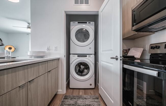 a small laundry room with a washing machine in it at Altis Grand Suncoast, Land O' Lakes, FL