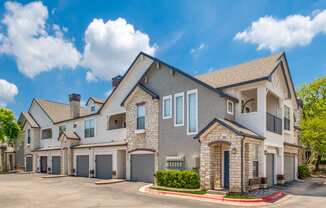 external view of a house with a driveway and garage doors