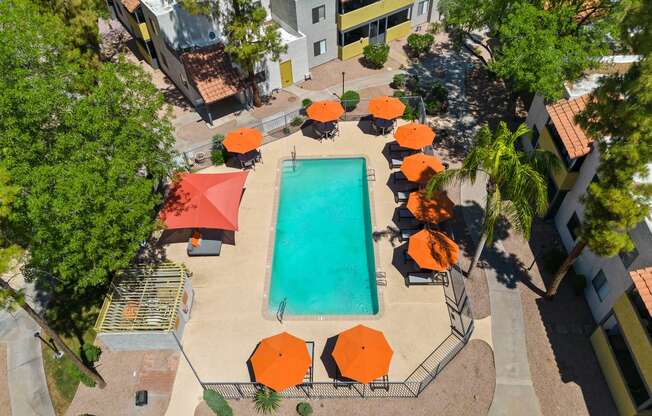 arial view of the resort style pool with orange umbrellas