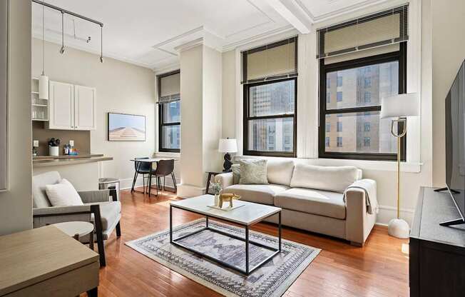 A living room with a white couch and a coffee table.