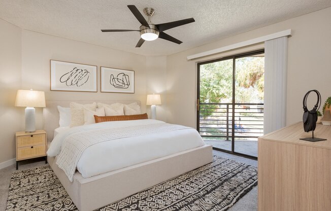 a bedroom with a bed and a ceiling fan