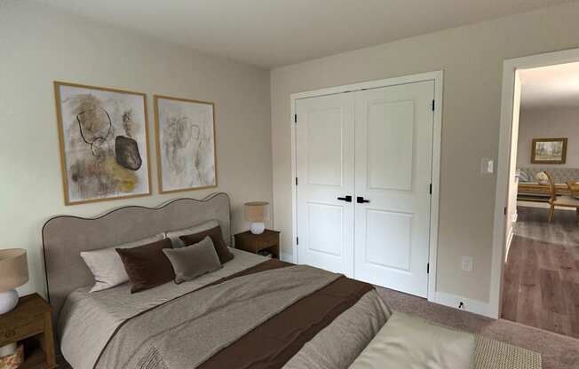 a bedroom with a bed and a door to a bathroom