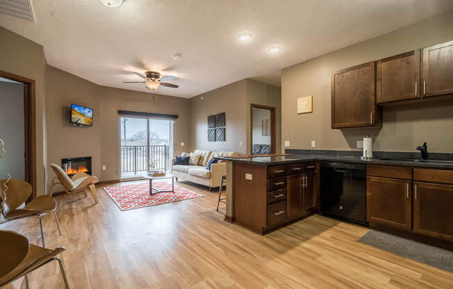 A modern kitchen with wooden cabinets and a black countertop.