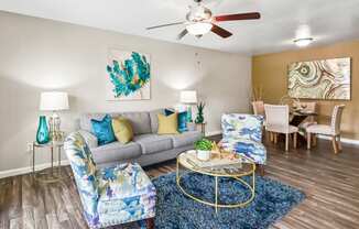 our apartments offer a living room with a couch a coffee table and a dining table