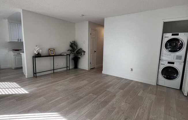 a living room with a washer and a dryer in it at Campbell West Apartments, Campbell, California